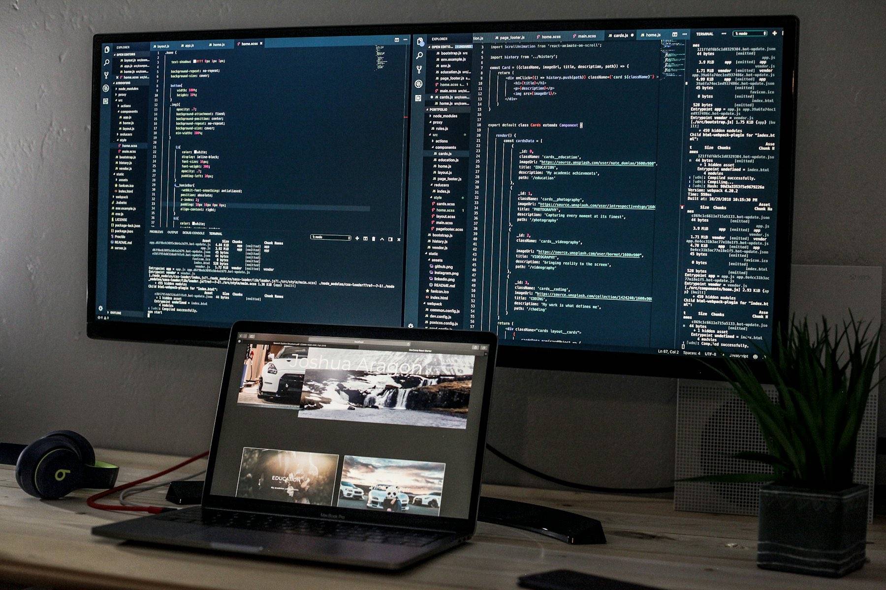 A developer workstation with code on multiple screens